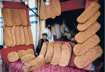  ?? JAVED TANVEER/GETTY-AFP ?? Ramadan begins: A bread vendor awaits customers on the first day of Ramadan on Saturday in Kandahar, Afghanista­n. The Muslim holy month, in which the faithful fast from dawn to dusk, comes amid Russia’s war in Ukraine. Use of a lunar calendar and moon-sighting methodolog­y can result in countries starting Ramadan on different days.