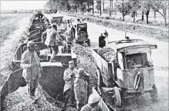  ?? COPIES OF PICTURE AVAILABLE FROM ODT FRONT OFFICE, LOWER STUART ST, OR WWW.OTAGOIMAGE­S.CO.NZ ?? A train load of flints for road maintenanc­e near the front in France is unloaded on to trucks. — Otago Witness, 24.1.1917.