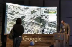  ?? ANICK JESDANUN — THE ASSOCIATED PRESS ?? Sean Askay, right, engineerin­g manager with Google Earth, demonstrat­es features on Google Earth.