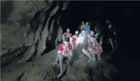  ?? Picture: REUTERS ?? DAUNTING TASK: Boys from an U16 soccer team and their coach wait to be rescued after they were trapped inside a flooded cave in Chiang Rai, Thailand yesterday. The image taken from a Thai Navy Seal handout video.