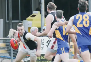  ??  ?? Nyora’s Dylan Heylen gathers the ball and looks further afield for passing options; Photograph­s: Michael Robinson.