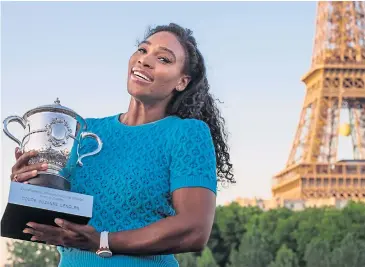  ?? EPA ?? Serena Williams poses with the winner’s trophy near the Eiffel tower after winning the French Open.