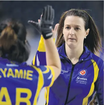  ?? SEAN KILPATRICK/THE CANADIAN PRESS ?? Alberta alternate skip Heather Nedohin high-fives third Lisa Eyamie after a win over Saskatchew­an during the Scotties Tournament of Hearts in St. Catharines, Ont., on Tuesday.