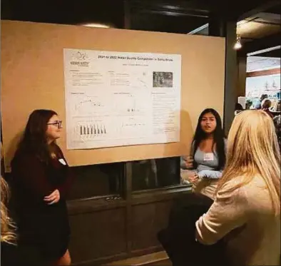  ?? Mary Donato / Hearst Connecticu­t Media ?? Students present their findings at the 2022 symposium on Dec. 1 in Westport.