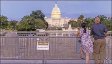  ?? — AFP photo ?? Tourists view the the US Capitol behind security fencing in Washington, DC.