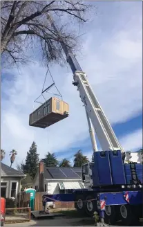  ?? COURTESY OF JOHN GEARY OF ABODU ?? A large crane installs a backyard unit, which was built by Abodu, in Jeff Thomson’s backyard on Feb. 4in San Jose.