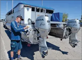  ??  ?? ORBA HALL PREPARES TO PUT HIS PONTOON BOAT into the water at Fisher’s Landing early Thursday morning. Hall made the trek all the way from his home in San Diego to spend the holiday weekend here on the Colorado River.