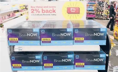  ?? TED S. WARREN/AP ?? Boxes of BinaxNOW’s COVID-19 self-testing kits are displayed for sale last month at a CVS store in Lakewood, Wash.