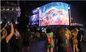  ?? Photograph: Ricky Vigil/Getty Images ?? Crowds watch as images from the James Webb telescope are broadcast on screens in Piccadilly Circus in London.