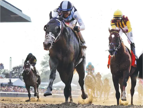  ??  ?? Tapwrit, left, ridden by Jose Ortiz, wins the 149th running of the Belmont Stakes horse race Saturday in Elmont, N.Y. Irish War Cry, ridden by Rajiv Maragh, right, finished second. (AP)