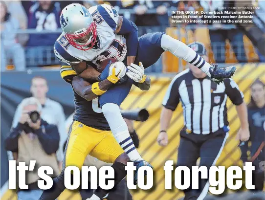  ?? STAFF PHOTO BY NANCY LANE ?? IN THE GRASP: Cornerback Malcolm Butler steps in front of Steelers receiver Antonio Brown to intercept a pass in the end zone.