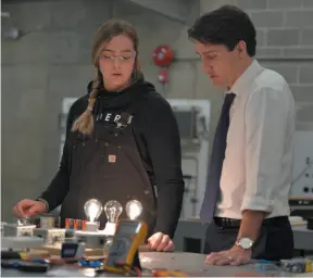  ?? CP PHOTO ?? Refrigerat­ion student Jaida Wallat talks with Prime Minister Justin Trudeau at the new Industrial Training and Technology Centre at Thompson Rivers University in Kamloops on Thursday.