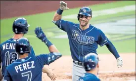  ?? Sean M. Haffey / Getty Images ?? The Rays’ Kevin Kiermaier is congratula­ted by teammates after hitting a three-run home run in the fourth inning against the Yankees during Game 3 of the American League Division Series on Wednesday at Petco Park in San Diego.