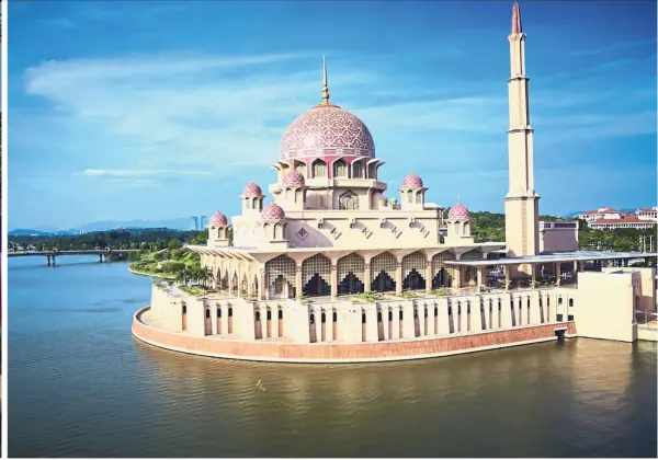  ??  ?? Putra Mosque is famed for its desert-pink colour and exquisite dome.