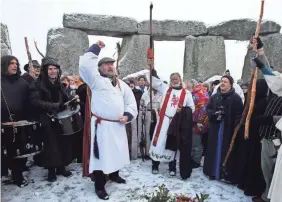  ??  ?? Hundreds of druids and pagans celebrate the winter solstice at Stonehenge in 2009 in Wiltshire, England. Crowds gather at the famous stone circle every year to mark the sunrise on the shortest day of the year. MATT CARDY/GETTY IMAGES