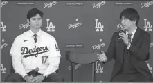  ?? AP ?? Shohei Ohtani (left) and interprete­r Ippei Mizuhara answer questions during a news conference in LA on Dec 14 last year.