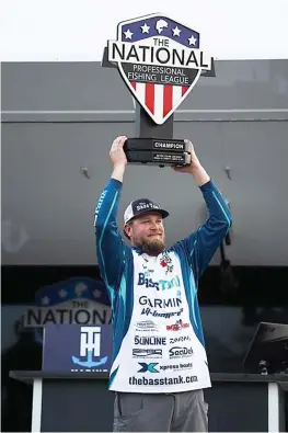  ?? Submitted photo ?? ■ John Soukup of Sapulpa, Oklahoma, raises his first-place trophy after winning the inaugural National Profession­al Fishing League tournament on March 13 at Lake Eufuala in Alabama.