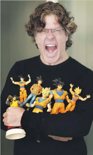  ?? Kirk McKoy Los Angeles Times ?? SEAN SCHEMMEL has voiced Goku in the English dub of “Dragon Ball” for 18 years, and he’s got the toys to show for it. How does he cope with the yelling? “It’s all about breath support,” he says.