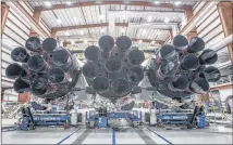  ?? CONTRIBUTE­D ?? SpaceX released this photo Wednesday of its new Falcon Heavy rocket in a hangar at Cape Canaveral, Fla. The rocket features three Falcon 9 first stage boosters.