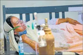  ?? PTI ?? A Covid patient on oxygen support waiting outside a hospital for admission in Jammu.