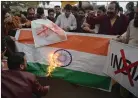  ??  ?? „ Pakistani protesters set fire to an India flag in Peshawar yesterday.