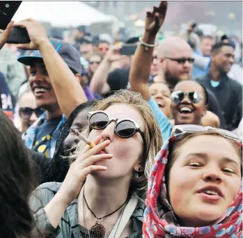  ?? BRENNAN LINSLEY/THE ASSOCIATED PRESS/FILE ?? Participan­ts enjoy a 4/20 marijuana festival in Denver. Michael Cohl says his World Cannabis Congress in Saint John, N.B., in June will be the ‘Davos of Cannabis.’