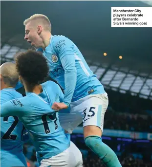  ??  ?? Manchester City players celebrate after Bernardo Silva’s winning goal