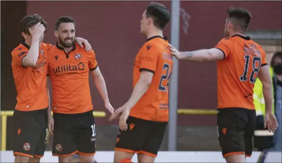  ??  ?? Dundee United’s Nicky Clark celebrates with his team-mates after making it 2-1 against Partick Thistle