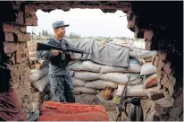  ?? REUTERS ?? An Afghan policeman keeps watch at the check post on the outskirts of Kabul, Afghanista­n.