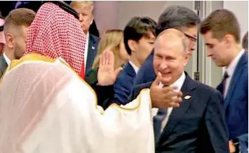  ??  ?? A video grab shows Russian President Vladimir Putin and Saudi's crown prince Salman exchanging high fives at the G20 summit