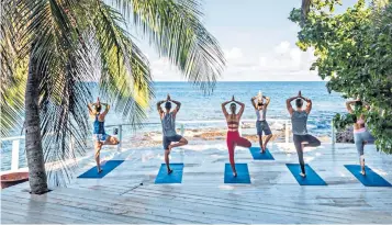  ??  ?? It’s all a balancing act during the yoga sessions at the BodyHolida­y resort