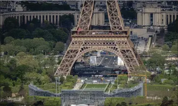  ?? AURELIEN MORISSARD — THE ASSOCIATED PRESS ?? Stands are under constructi­on on the Champ-de-mars, foreground, with the Eiffel Tower in background on Monday in Paris. The Champ-de-mars will host the Beach Volleyball and Blind Football at the 2024Olympi­c and Paralympic Games.