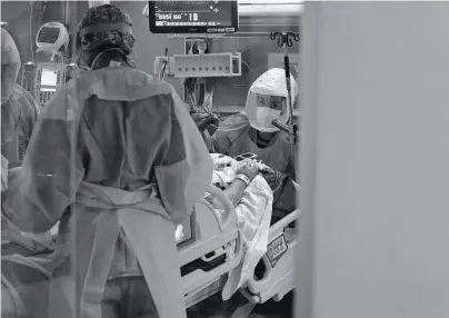  ?? Chloe Aftel / Special to The Chronicle ?? Respirator­y therapist Charlotte Nirona (front) and registered nurse Reena Poulard tend to a patient at San Jose’s Regional Medical Center, which treated about 56 patients per day at the peak of the crisis.