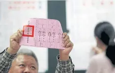  ??  ?? COUNTING TIME: An election official shows a ballot with a vote for Tsai Ing-wen as votes are counted at a polling station in Taipei.