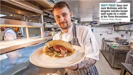  ?? Picture: Pete Stonier ?? TASTY TREAT: Sous chef Jack Mcginley with the bespoke oatcake burger staff made for a visitor at the Three Horseshoes.