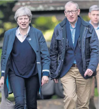  ?? Pictures: DAVID HARTLEY ?? Theresa May, leaving church with husband Philip yesterday, has come under fire over her transition deal