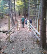  ?? PHOTO PROVIDED ?? Volunteers work on a bridge at the newBarkers­ville Trails prior to its opening this weekend.