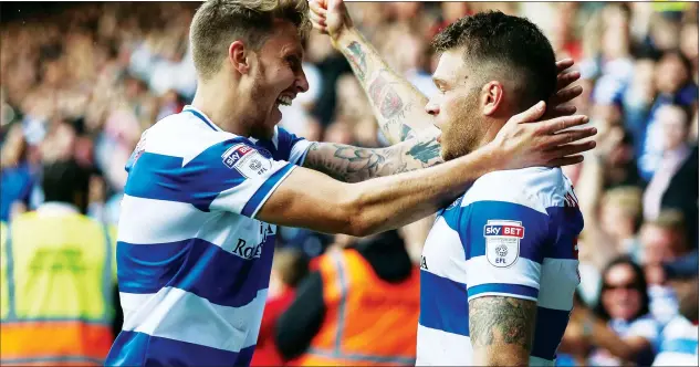  ?? PICTURES: PSI/Toyin Oshodi ?? TON-UP: Jamie Mackie, right, celebrates with Luke Freeman after scoring the opener on his 100th start for QPR