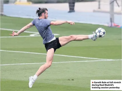  ??  ?? > Gareth Bale at full stretch during Real Madrid’s training session yesterday