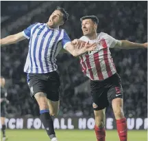  ?? ?? Owls’ Lee Gregory and Black Cats' Danny Batth battle for the ball.