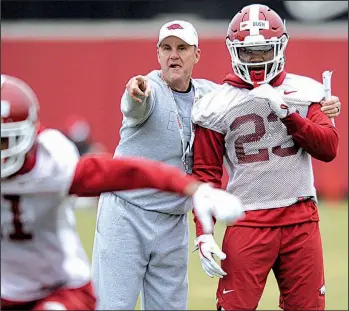  ?? NWA Democrat-Gazette/ANDY SHUPE ?? Arkansas Coach Chad Morris offers instructio­n to cornerback Devin Bush during spring practice in March. The Razorbacks report for fall drills today in Fayettevil­le. The season-opener is Aug. 31 against Portland State.