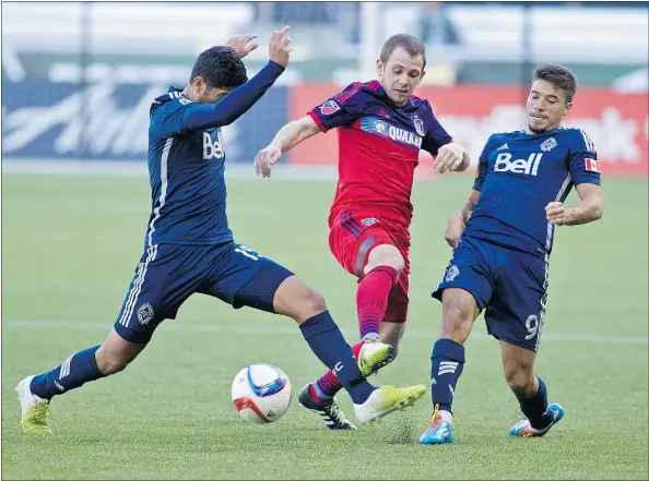  ?? CRAIG MITCHELLDY­ER-USA TODAY SPORTS ?? Chicago Fire midfielder Harry Shipp, centre, battles for the ball with Whitecaps forward Nicolas Mesquida, right, and midfielder Matias Laba during the second half at Providence Park. Vancouver hosts Toronto FC in its season opener.
