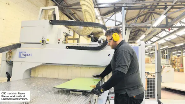  ??  ?? CNC machinist Reece Riley at work inside at LIDR Contract Furniture.