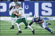  ?? Zach Bolinger / Associated Press ?? New York Jets quarterbac­k Sam Darnold (14) scrambles away from a diving Indianapol­is Colts defensive end Tyquan Lewis during Sunday’s game in Indianapol­is.
