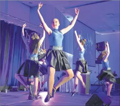  ?? DESIREE ANSTEY/JOURNAL PIONEER ?? Alysha Trenholm and her fellow dancers jump and twirl to the notes bagpiper James MacHattie plays for a Highland dance during the Robbie Burns Fundraisin­g Gala.