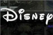  ?? FRANCOIS MORI — THE ASSOCIATED PRESS FILE ?? This file photo shows a sign at the Disney store on the Champs Elysees Avenue in Paris, France. The Walt Disney Co. reports earnings Tuesday.