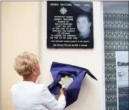  ??  ?? Anne McCabe officially unveils the plaque to her late husband