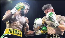  ?? GLADSTONE TAYLOR/PHOTOGRAPH­ER ?? Jamaica’s Kemahl ‘Hitman’ Russell (left) lands a hard punch to the body of Michi Muñoz before stopping the Mexican in the second round of the Junior NABF Middleweig­ht title at the National Arena on Friday night.