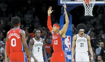  ?? MATT SLOCUM — THE ASSOCIATED PRESS ?? Philadelph­ia 76ers’ Tobias Harris (12) celebrates past Josh Richardson (0) and Brooklyn Nets’ Taurean Prince (2) and Jarrett Allen (31) after Harris made a 3-pointer during the second half of an NBA basketball game, Wednesday in Philadelph­ia.