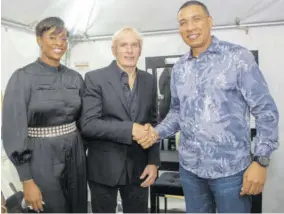 ?? (Photo: Garfield Robinson) ?? Prime Minister Andew Holness (right) shakes hands with superstar Michael Bolton ahead of him taking the stage for the charity concert event at Couples San Souci last week. Sharing in the moment is Holness’s wife, Member of Parliament Juliet Holness.